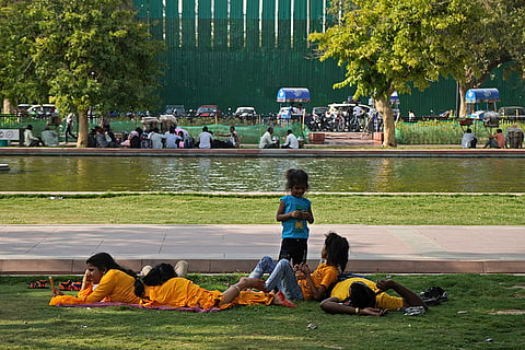 A family rests near India Gate
